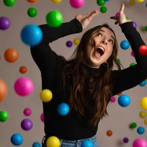 picture of women amongst many falling balls